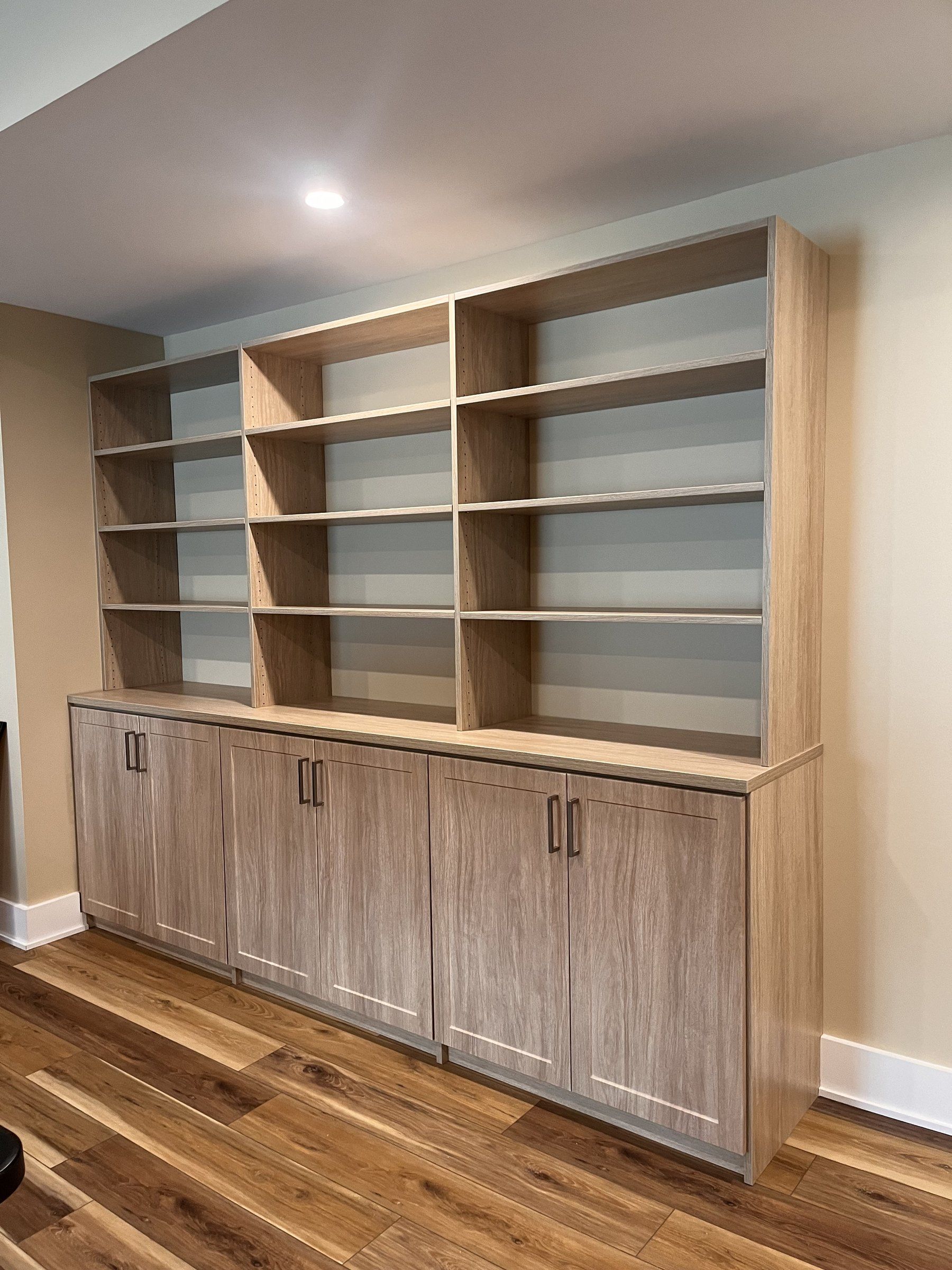 Built-in shelving wall lower cabinets, installed by Closets For Less