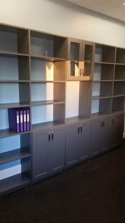 Charcoal built-in office shelving with lower cabinets