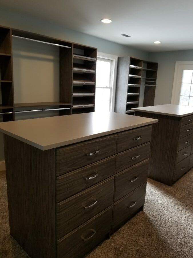 Walk-in closet double island dark drawers, installed by Closets For Less