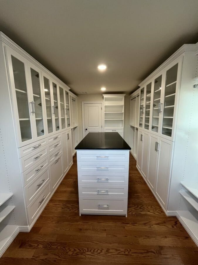 Walk-in closet glass door cabinets island, installed by Closets For Less