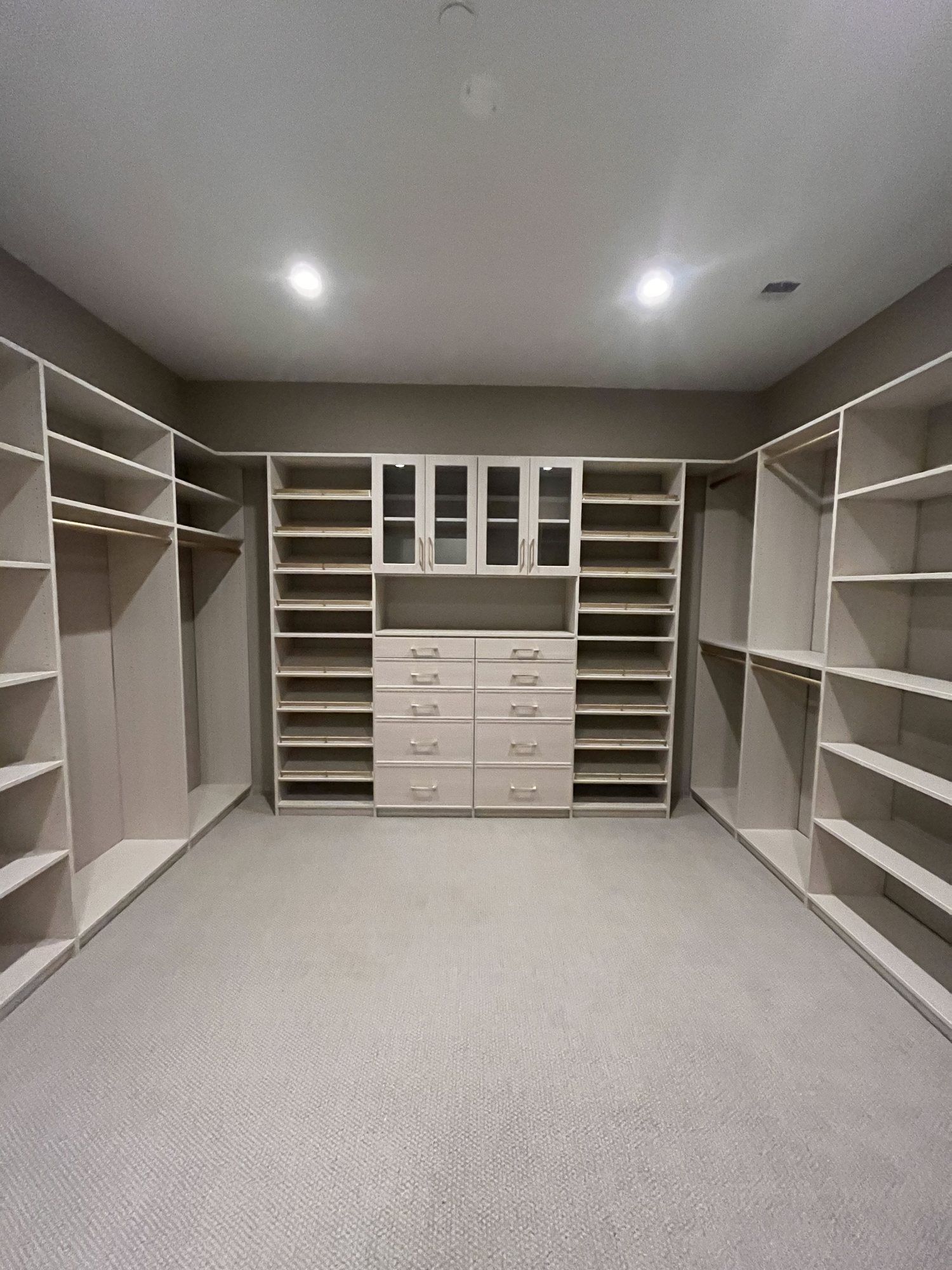 Walk-in closet gray carpet drawer bank, installed by Closets For Less