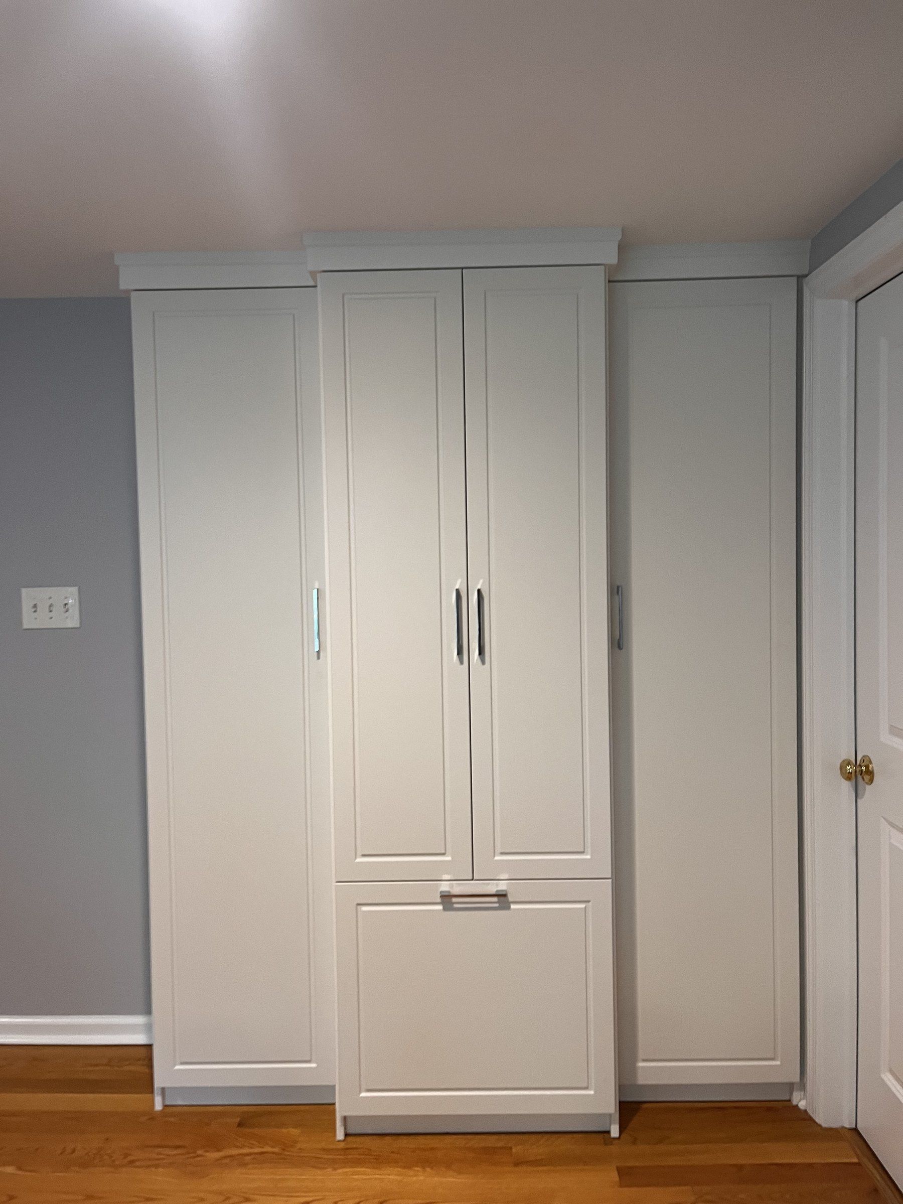 White wardrobe cabinet doors, installed by Closets For Less