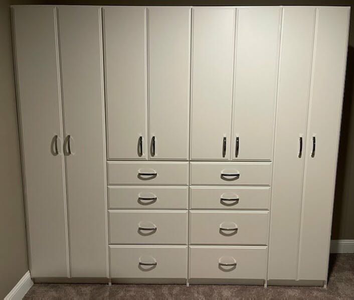 White wardrobe cabinets drawers, installed by Closets For Less