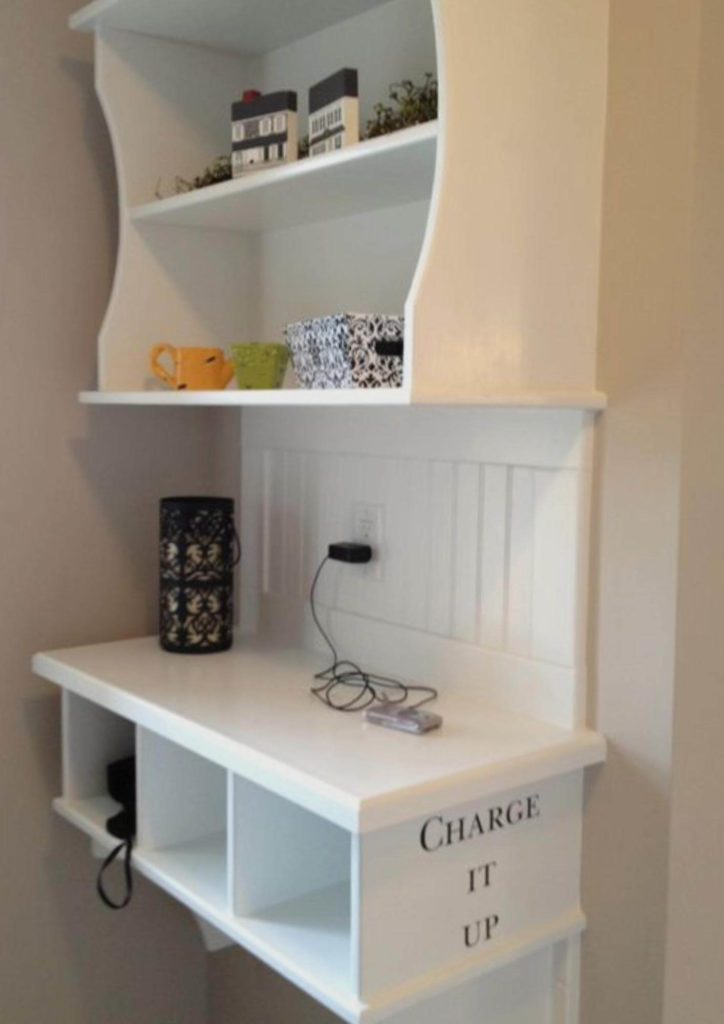 custom charging station in mudroom. White wood shelf with compartments