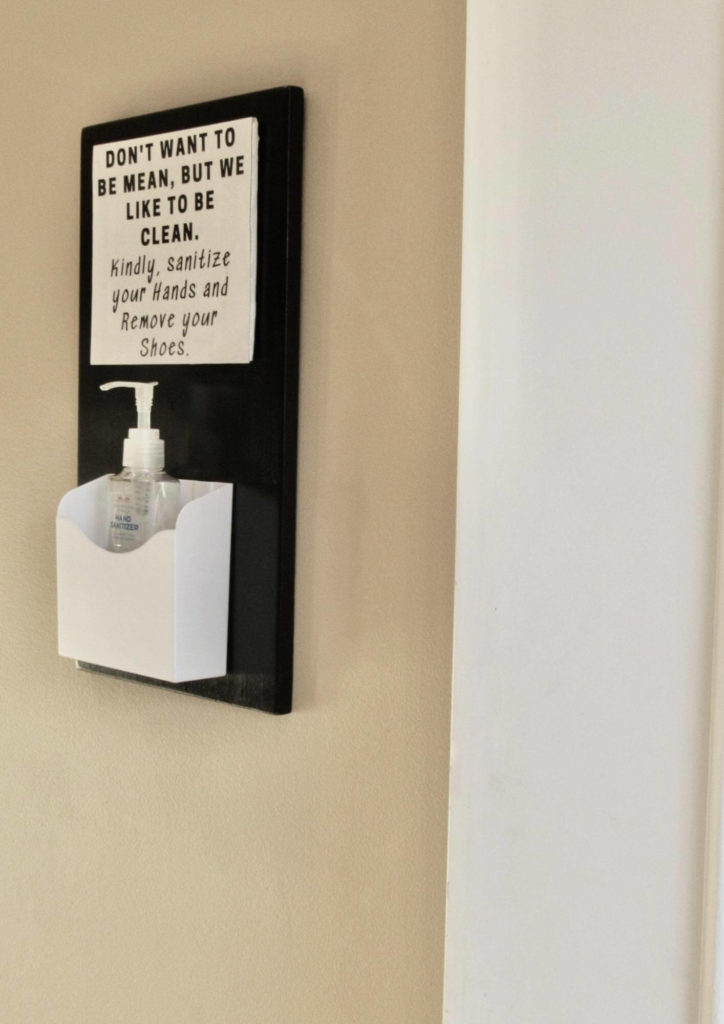 hanging hand sanitizer station with pump and sign