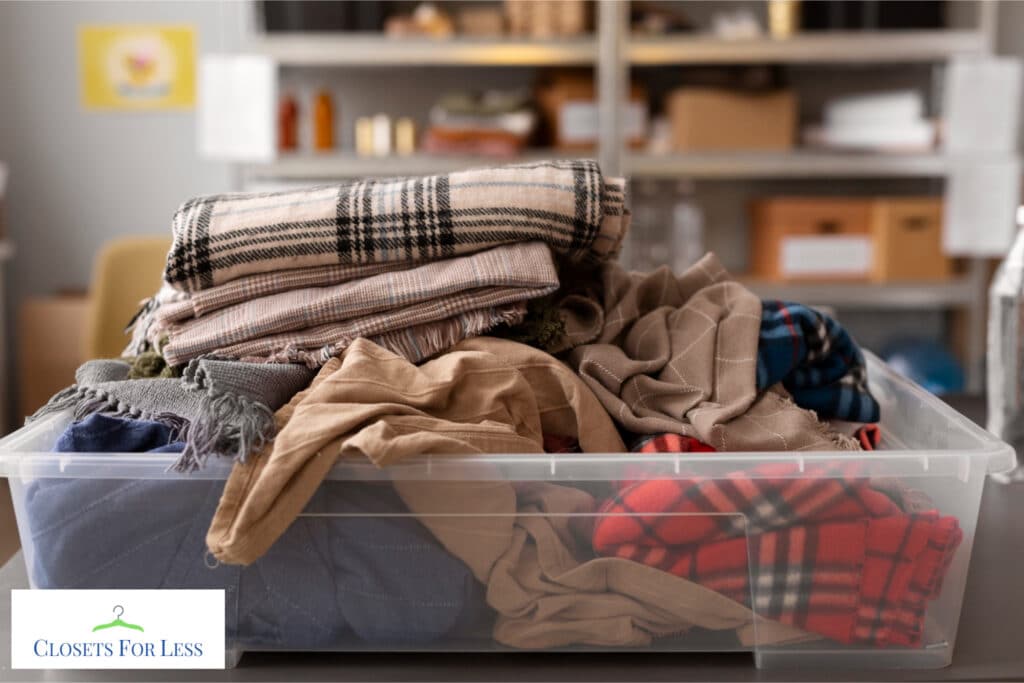 Clothes piled messily inside a clear plastic container, illustrating a cluttered and disorganized state before decluttering.