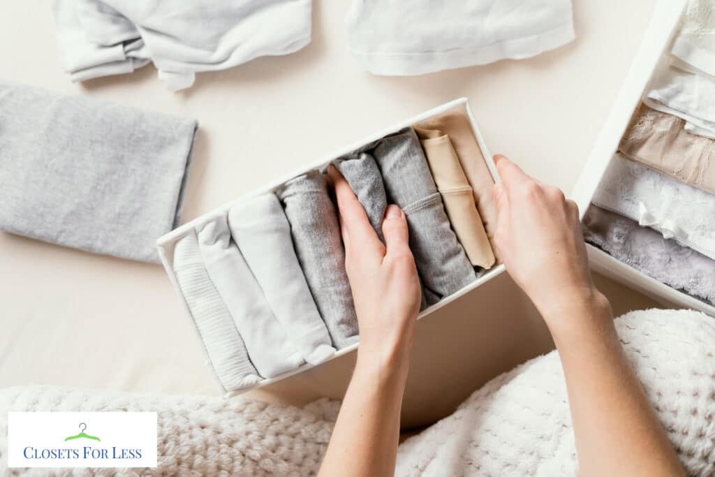 Clothes folded vertically using the Marie Kondo method, neatly arranged in a drawer for easy visibility and access.