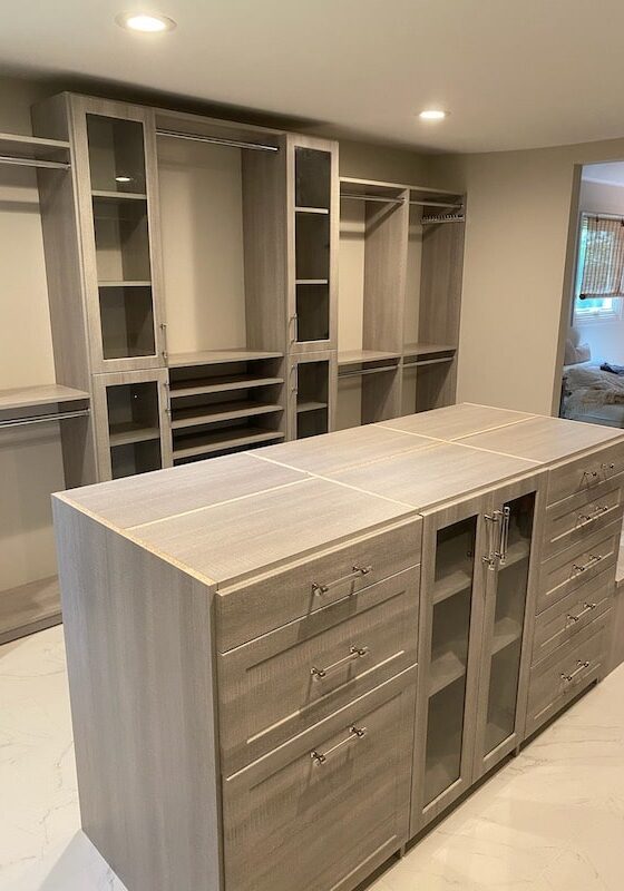 new custom designed closet in horsham pa with gray shelves and cabinets and closet island