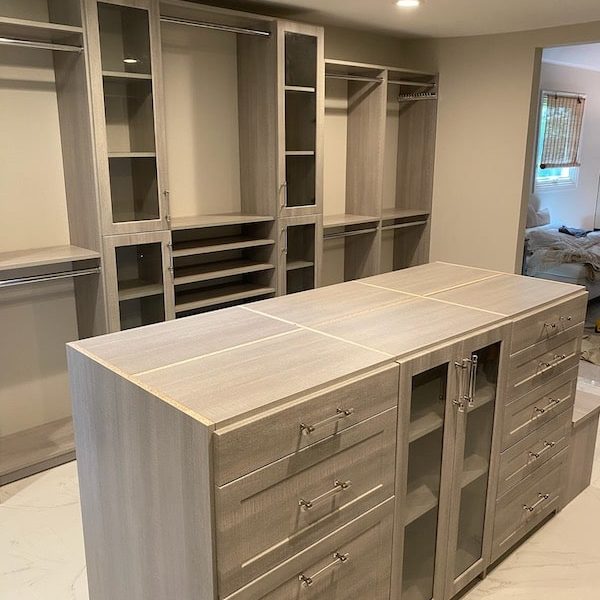 new custom designed closet in horsham pa with gray shelves and cabinets and closet island